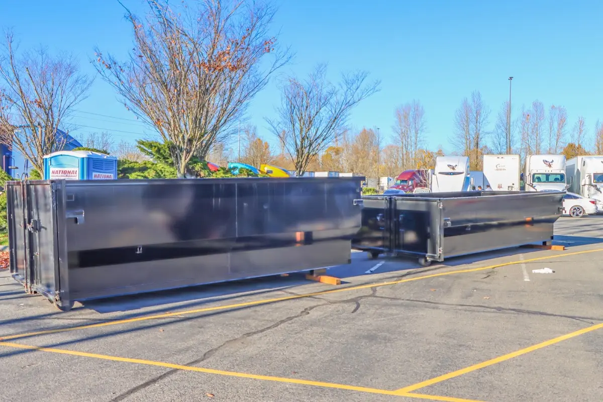 Professional dumpster rental service with roll-off container on residential driveway in Spring Valley